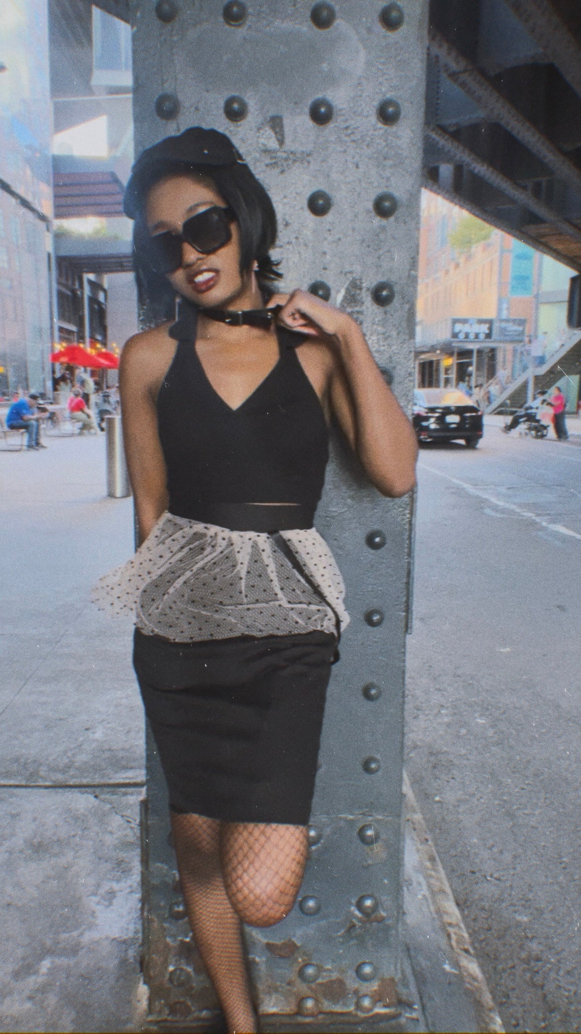woman wearing black cotton pencil skirt with signature ribbon chain on a city street for kimyoung brand luxury women's fashion